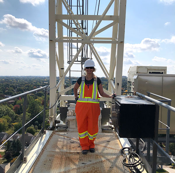 Female inspector standing on catwalk